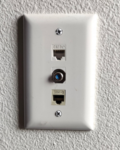 Wall Jack with Cat 6 labeled at bottom and another port on top, cable port in middle.